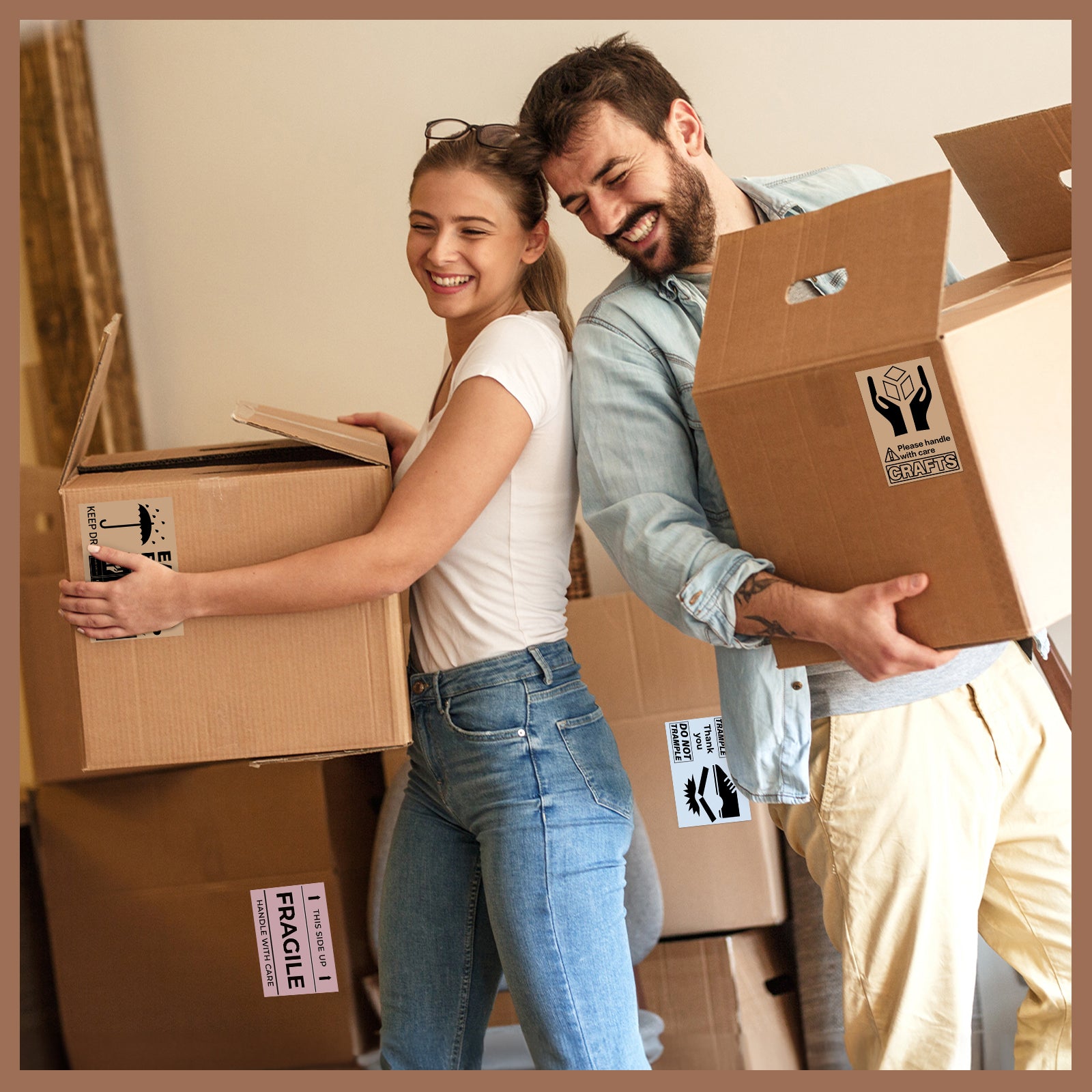 Smiling couple moving boxes with thermal shipping and fragile label stickers.