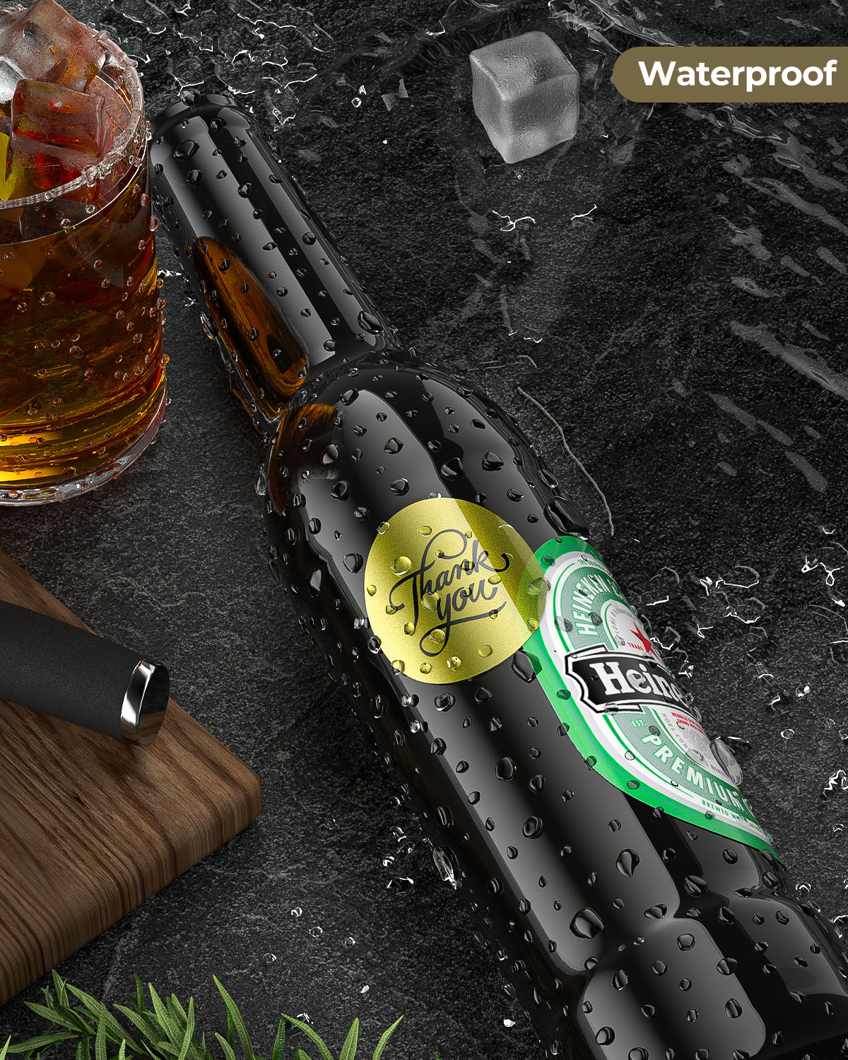 Gold glitter waterproof thank you label on wet beer bottle, ice and drink on black stone surface