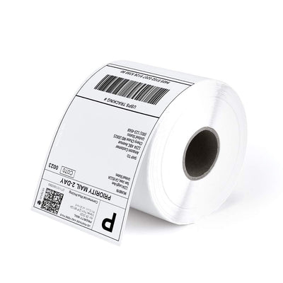 Roll of thermal shipping labels with printed barcode and address, used for package labeling