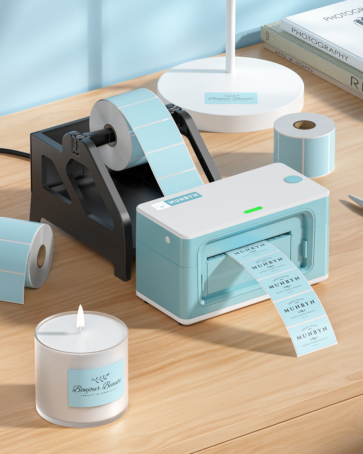 Thermal label printer with blue shipping labels on desk, rolls of labels, and candle nearby.