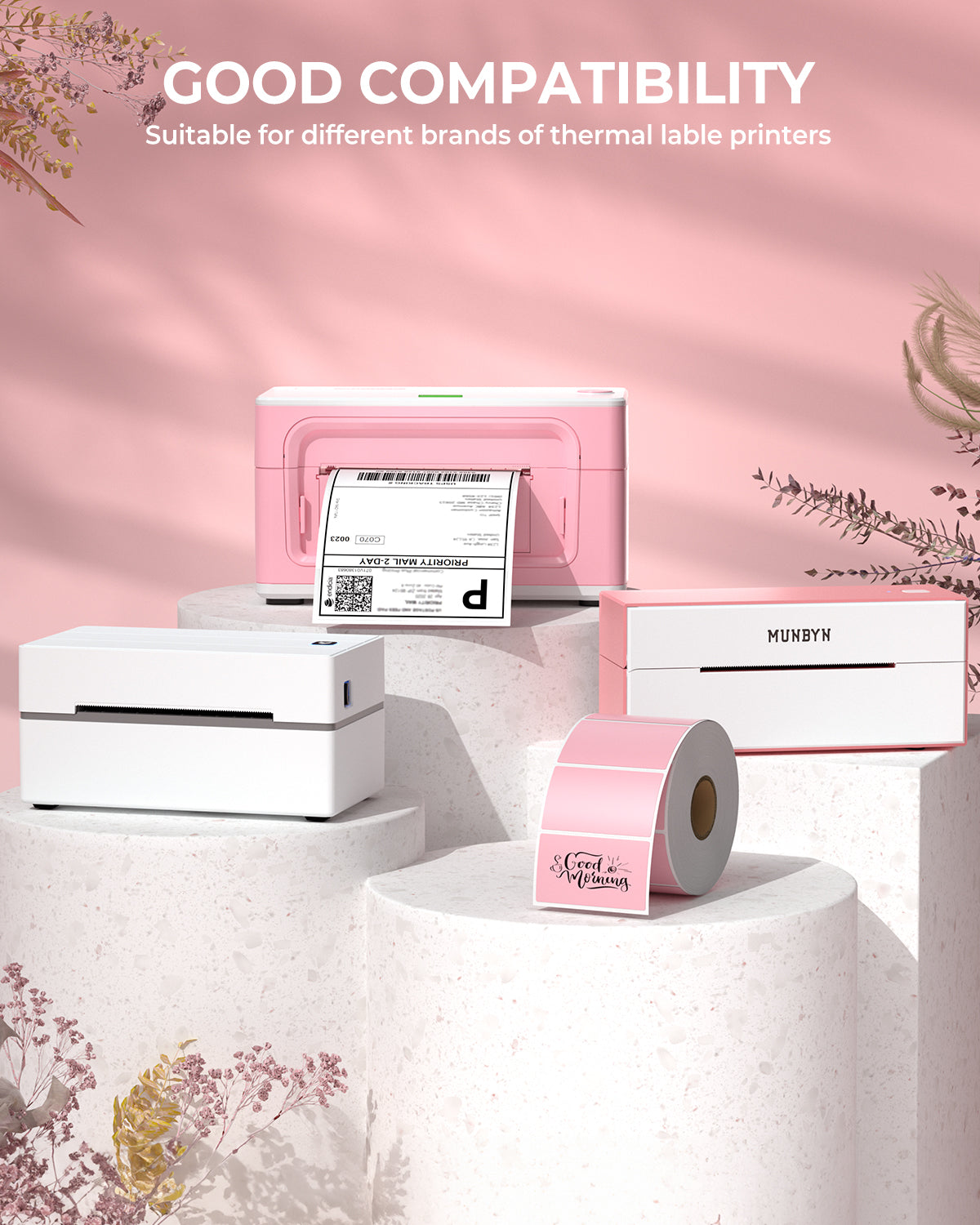 Assorted pink and white thermal printers with label rolls on display pedestals, shipping labels visible.