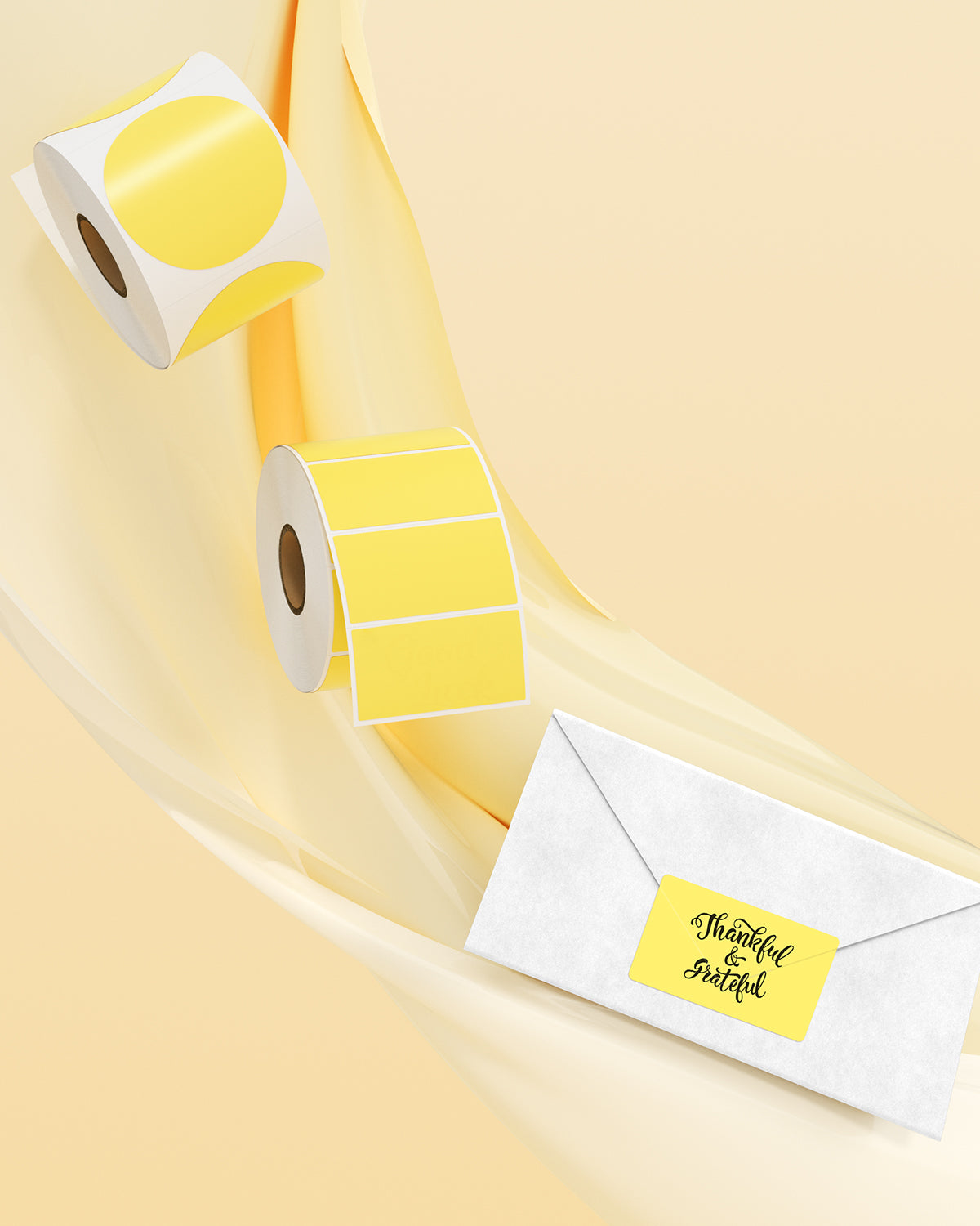 Yellow thermal label rolls and a white envelope with a yellow shipping label, on a light background.