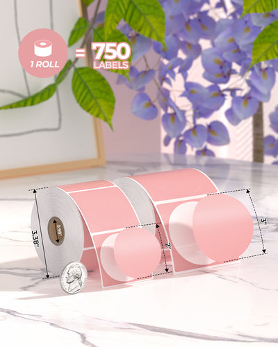 Pink round thermal labels in 2x2 and 3x3 inch sizes, 1 roll with 750 labels on marble table.
