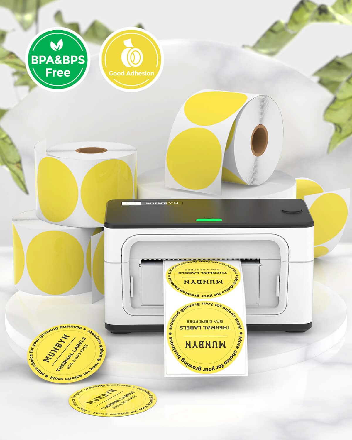 Two 2-inch round labels printed on MUNBYN label printer paper, showing example designs and adhesive backing.