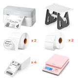 Thermal label printer, label holder, rolls of shipping and thank you labels, label sheets, and a pink digital shipping scale.