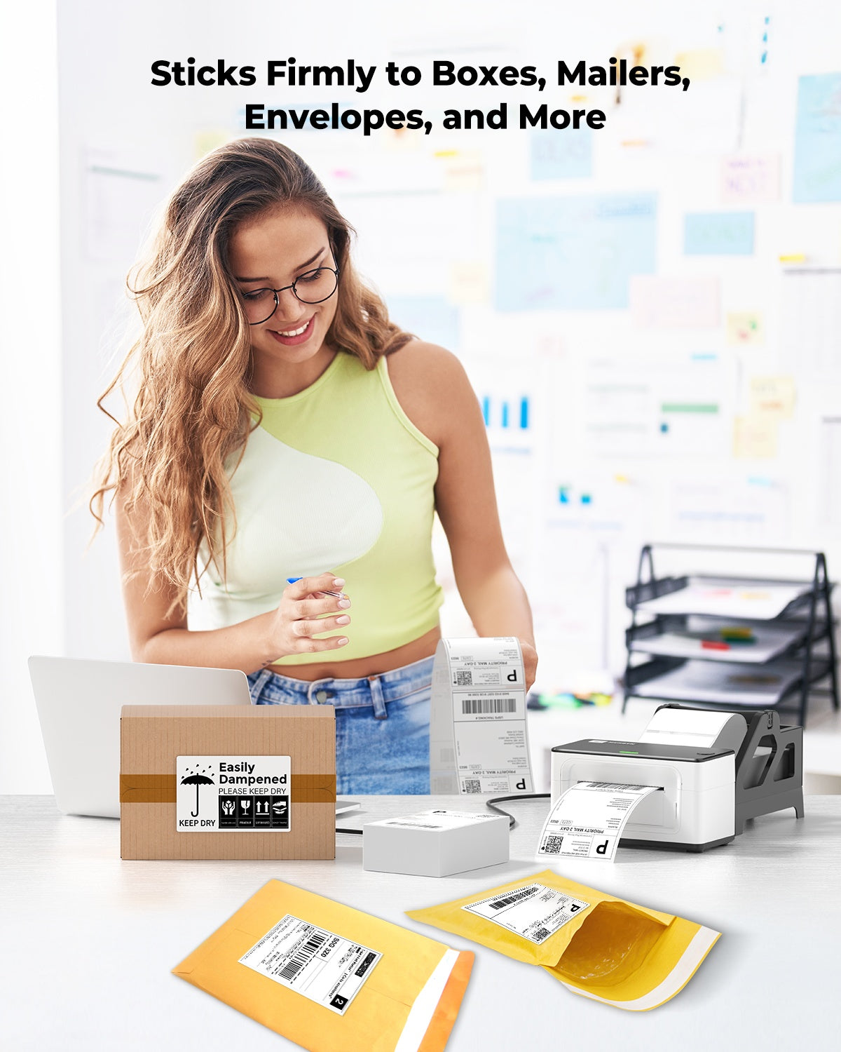 Woman in office using thermal label printer with shipping labels on boxes and mailers