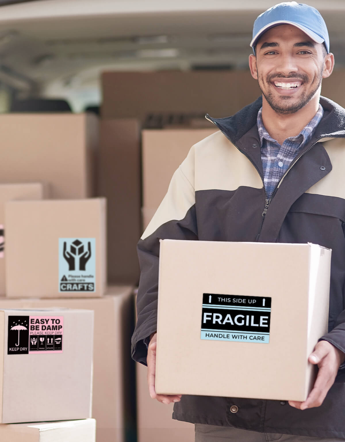 Delivery worker holding box with fragile shipping label, surrounded by packages with thermal shipping labels in a van.