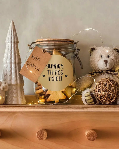Glass jar of Christmas cookies with 'Yummy Things Inside' label on a shelf, holiday decor
