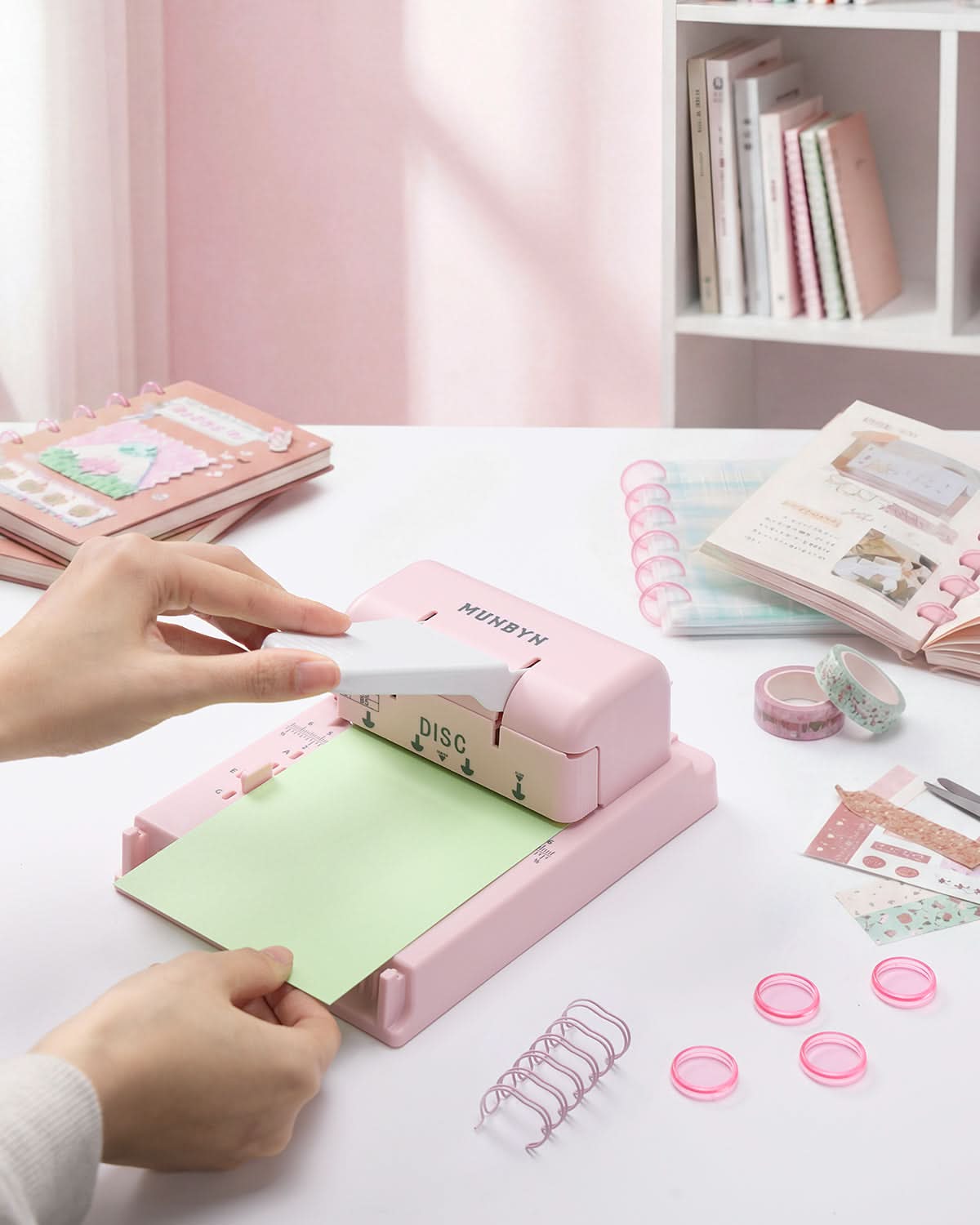 MUNBYN FB001 Multi Binding Machine in pink, showing its compact design and binding features for professional document binding.