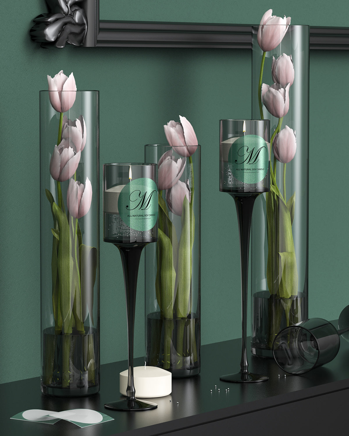 Pink tulips and a green label candle in tall glass vases on a modern black mantel