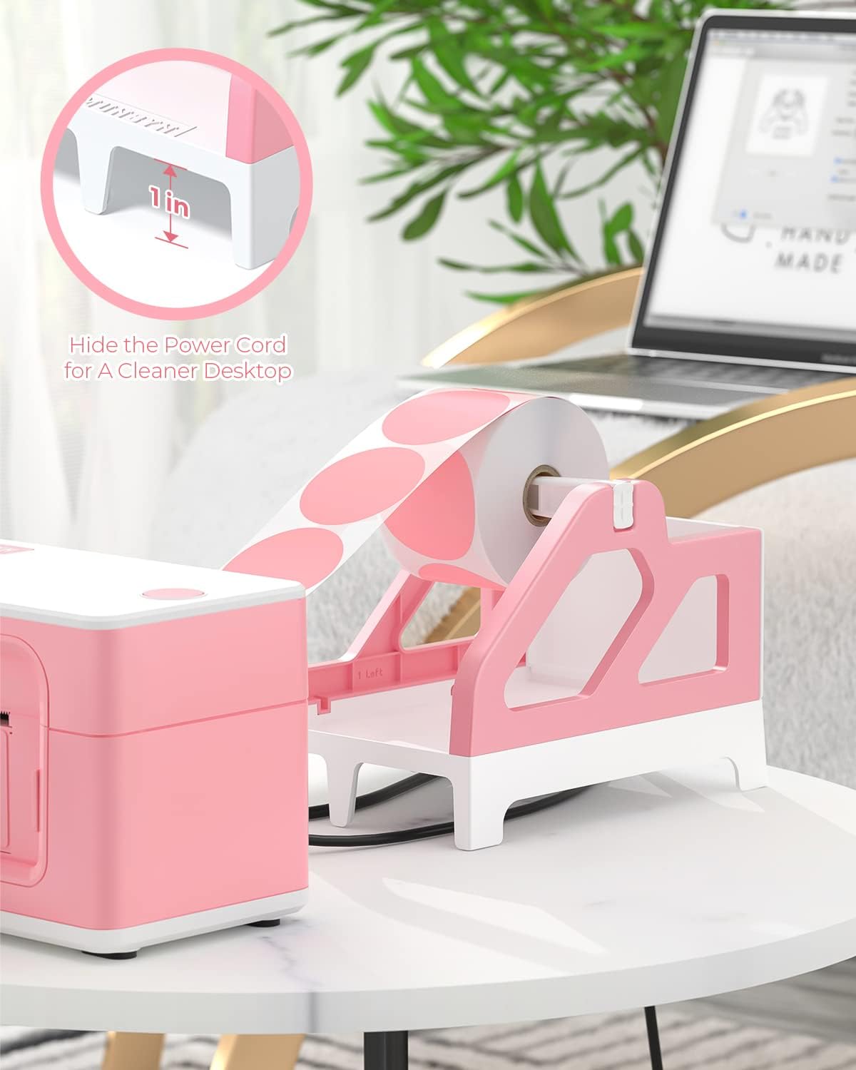 Pink and white thermal label holder with label roll on desktop, ideal for shipping organization
