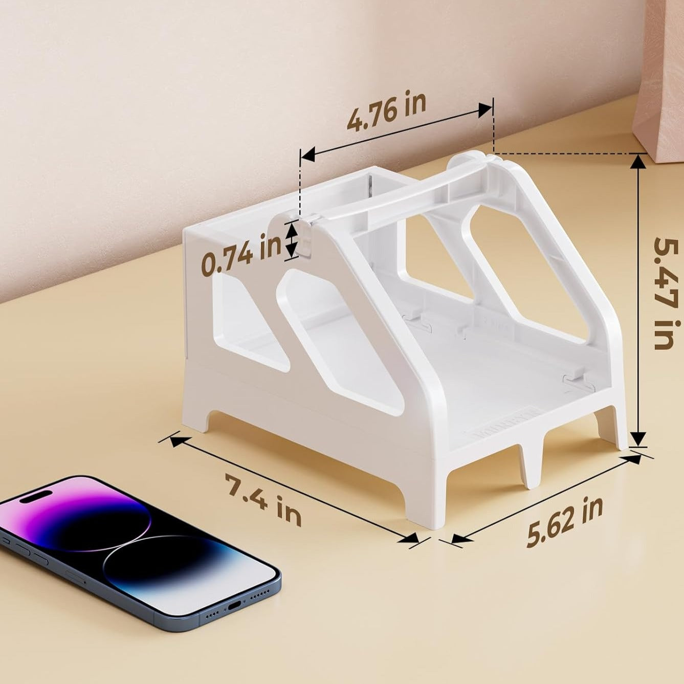 White plastic label holder with measurements, shown on a desk beside a smartphone.