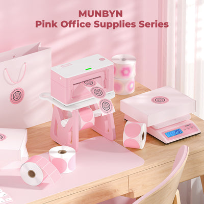 Pink thermal printer, scale, and labels set on a pastel office desk, pink office supplies theme