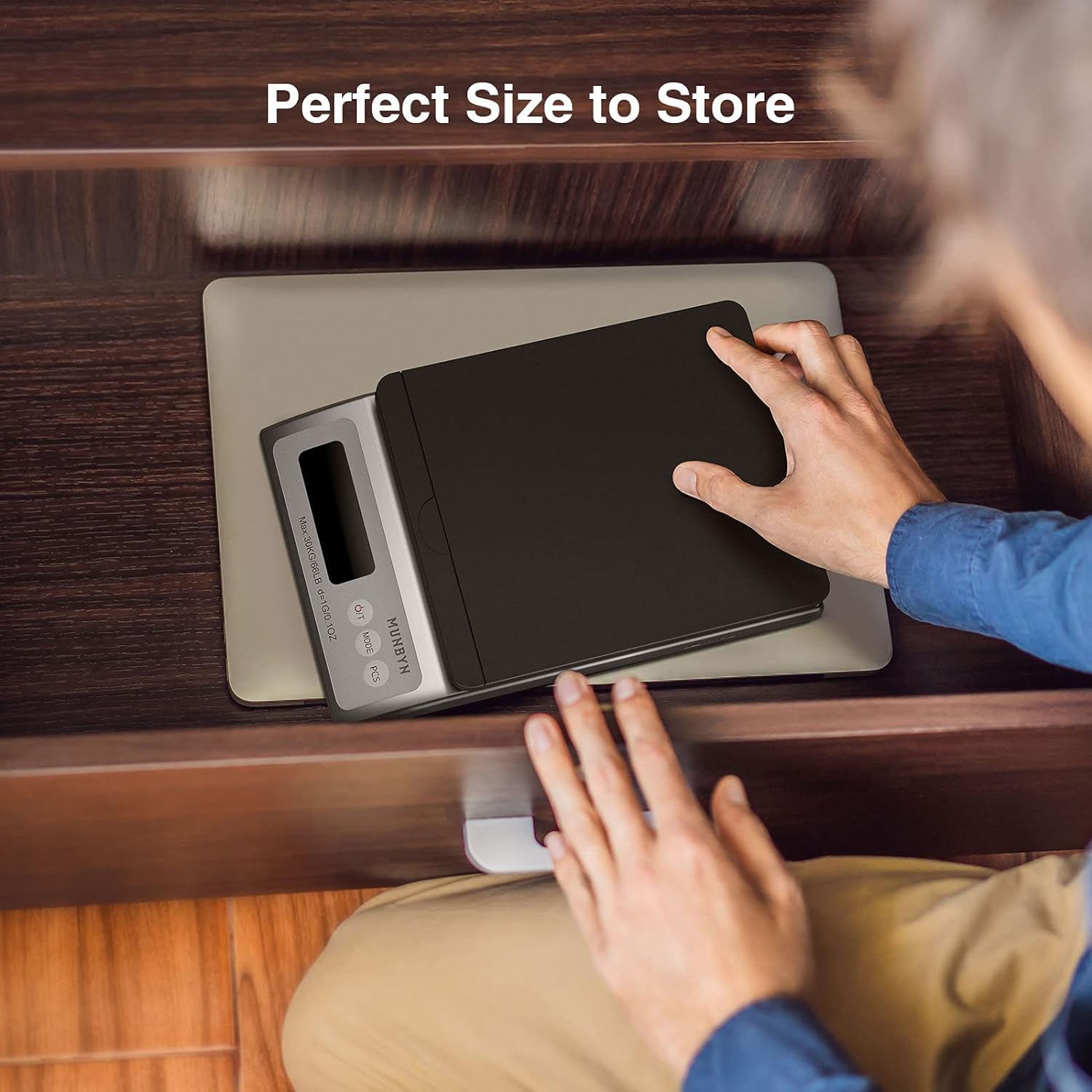 Compact digital shipping scale stored in a wooden drawer, ideal for small business use