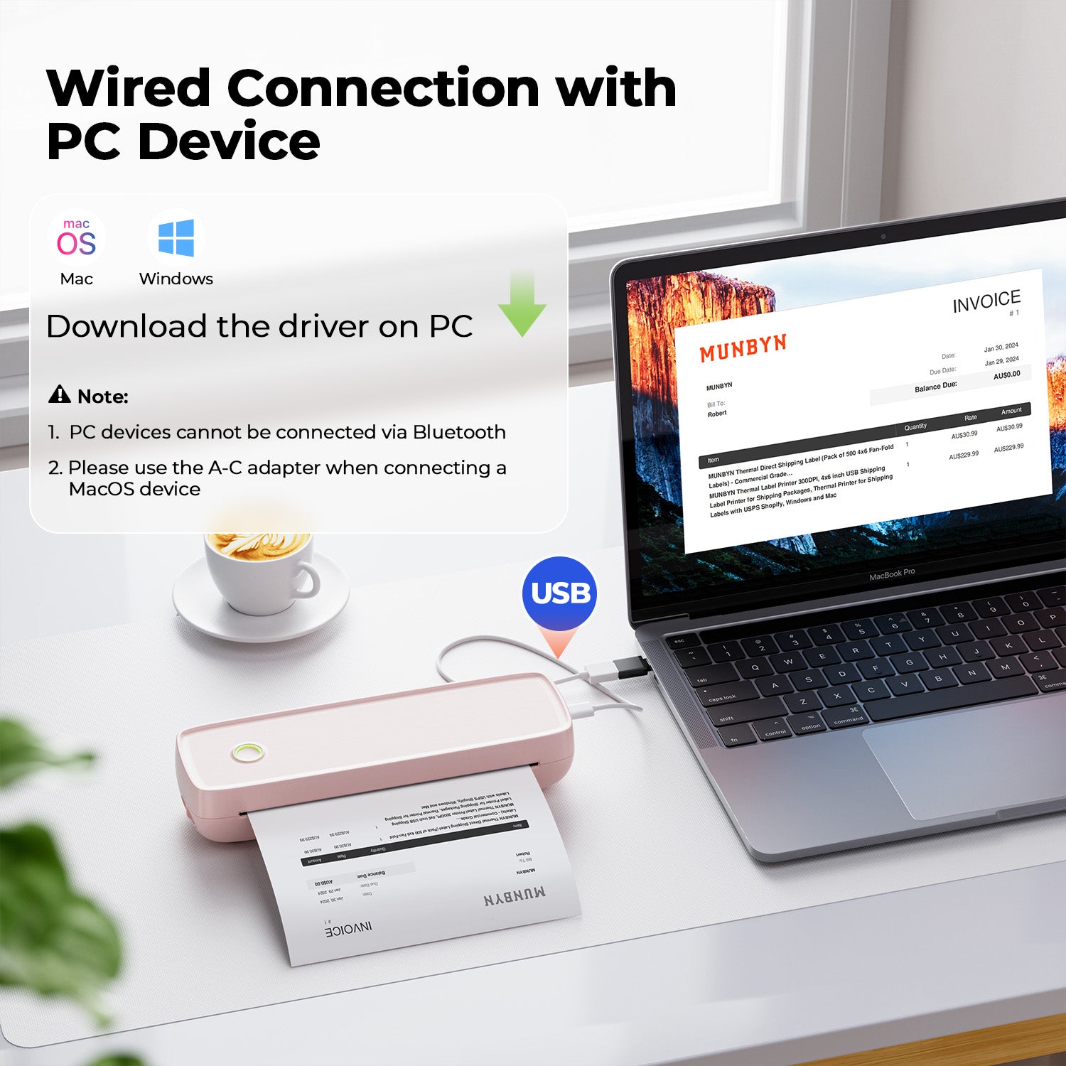 USB-connected portable thermal printer printing invoice beside laptop on desk