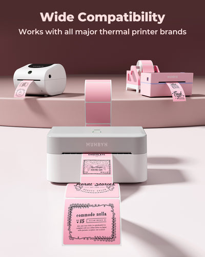 Thermal label printers displaying pink decorative shipping labels on a pastel background