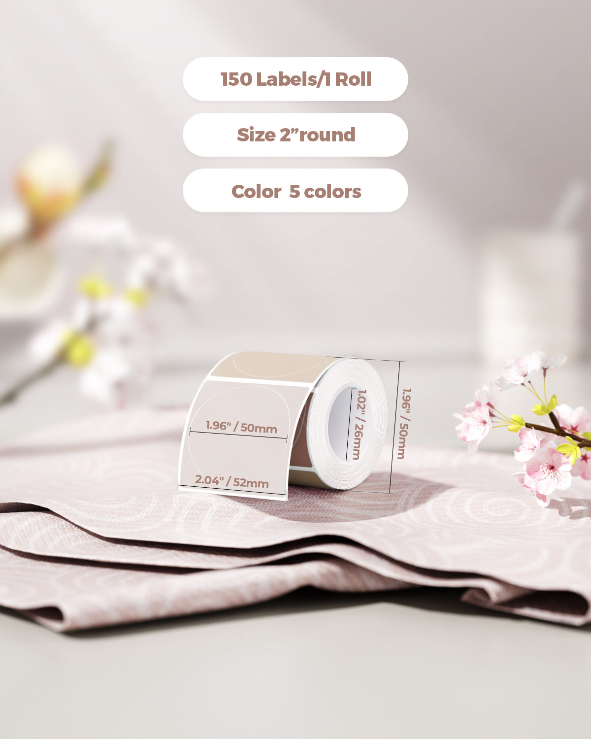 Roll of round 2-inch thermal labels in assorted pastel colors, 150 labels per roll, on a soft pink fabric with flowers.