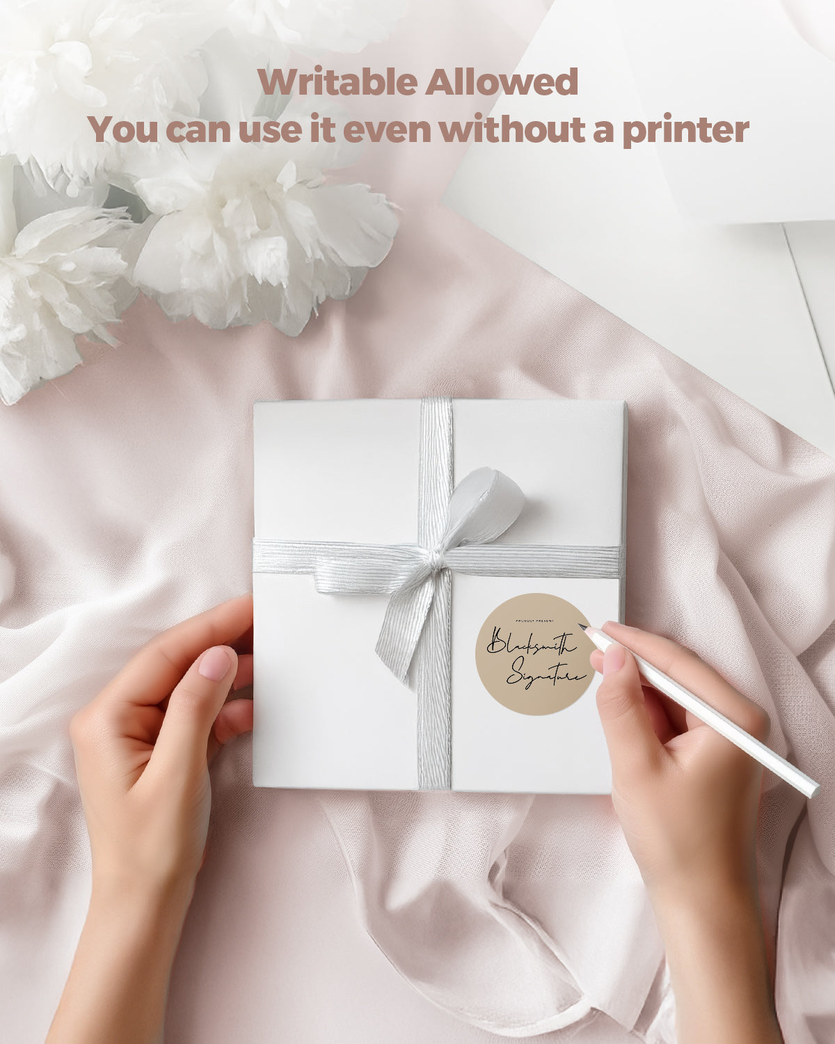 Handwriting on writable thermal label sticker attached to a white gift box with ribbon.