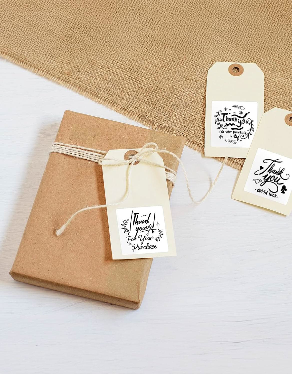 Square MUNBYN label printer paper, 2x2 inch adhesive labels, blank white labels on a sheet for printing and organization.