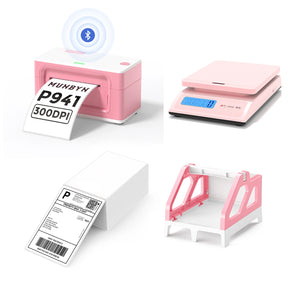 The MUNBYN 941B pink Bluetooth label printer kit includes a printer, a shipping scale, a label holder, and a stack of shipping labels